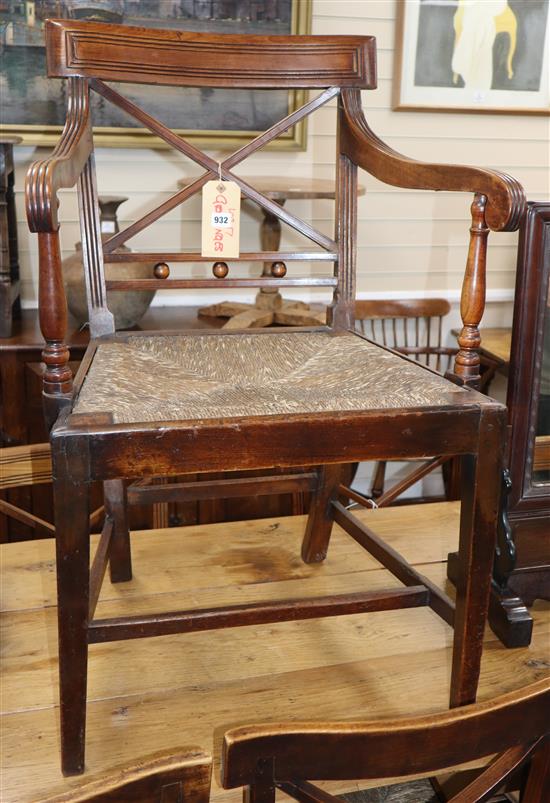 A set of six Regency fruitwood and rush seated chairs, including one carver